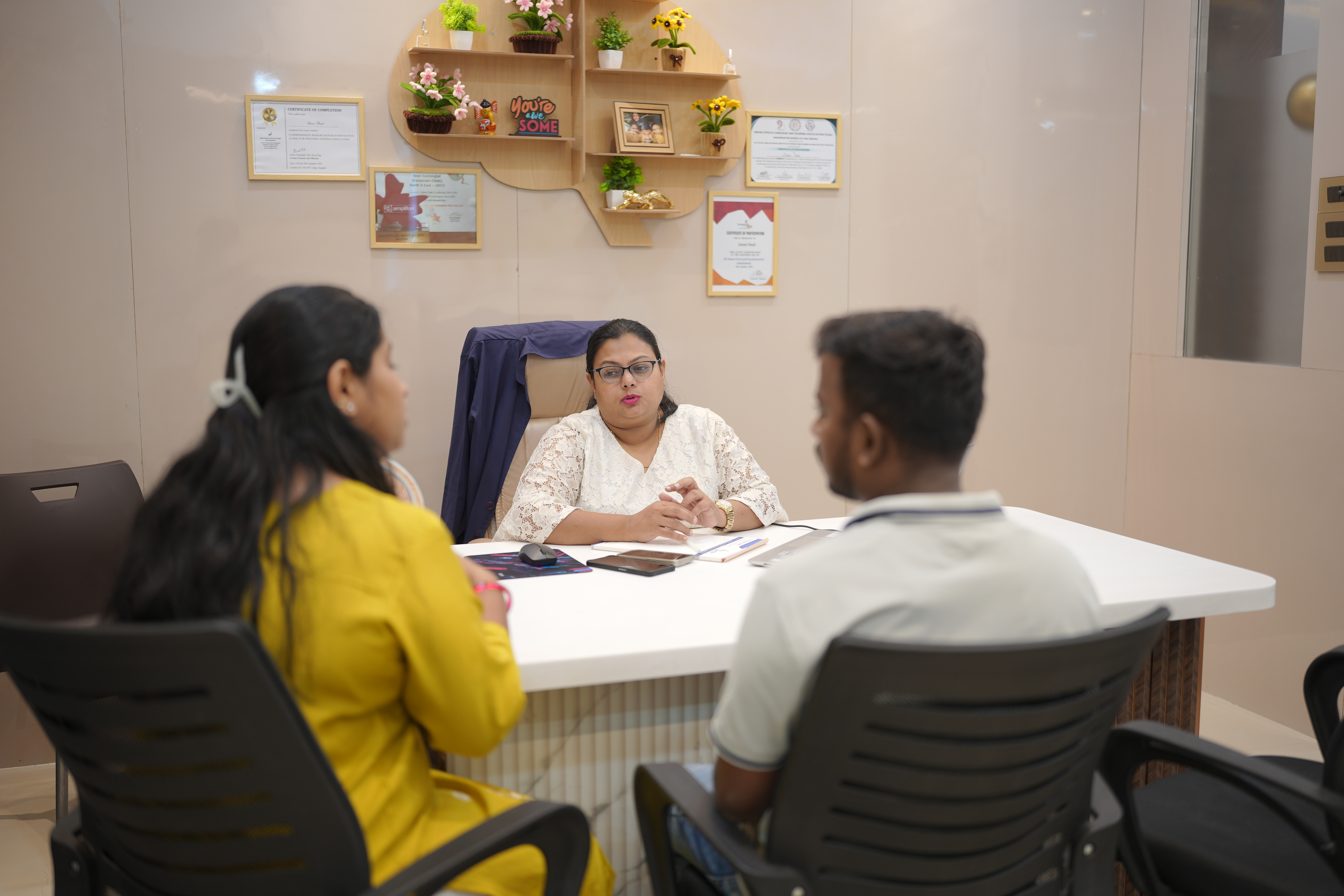 Therapist guiding parents about child communication development